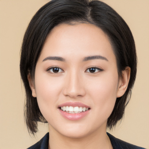 Joyful asian young-adult female with medium  black hair and brown eyes