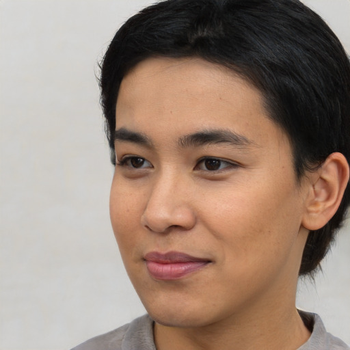 Joyful asian young-adult female with short  black hair and brown eyes