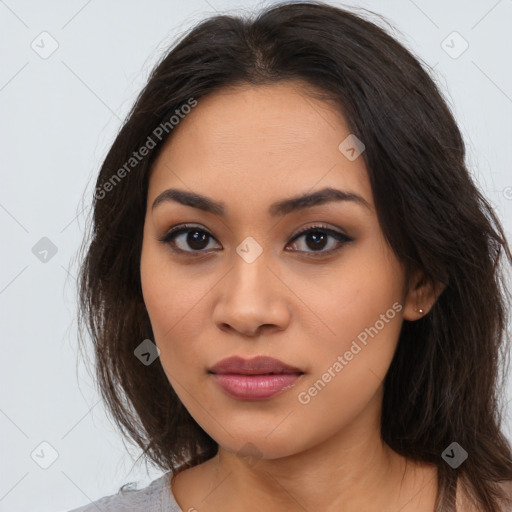 Joyful latino young-adult female with long  brown hair and brown eyes