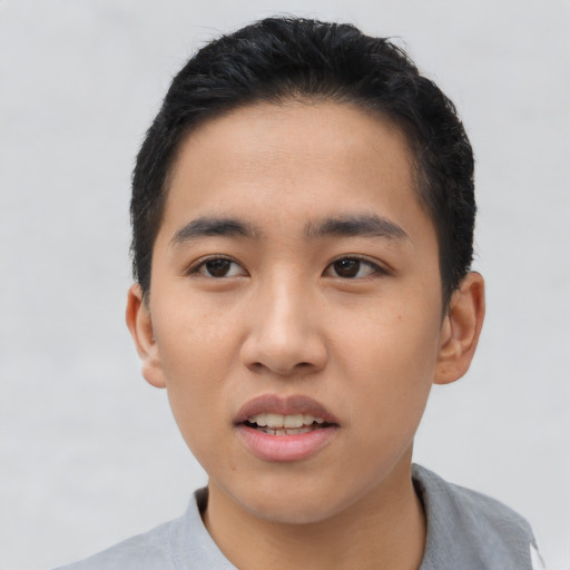 Joyful asian young-adult male with short  black hair and brown eyes