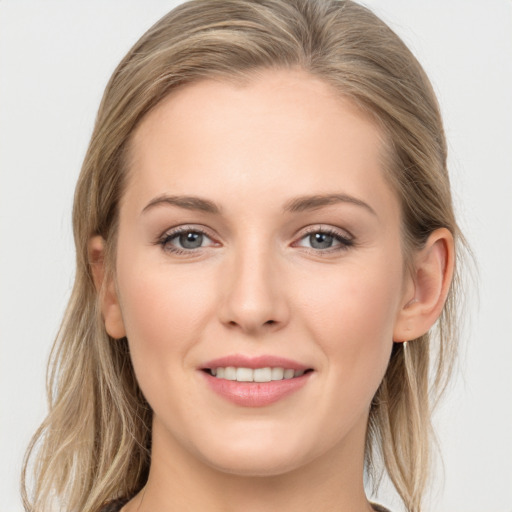 Joyful white young-adult female with long  brown hair and grey eyes