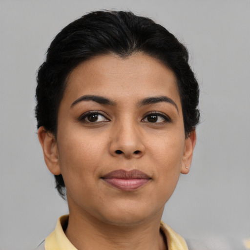 Joyful latino young-adult female with short  brown hair and brown eyes