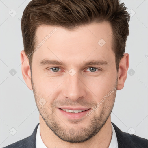 Joyful white young-adult male with short  brown hair and grey eyes