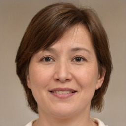 Joyful white adult female with medium  brown hair and brown eyes