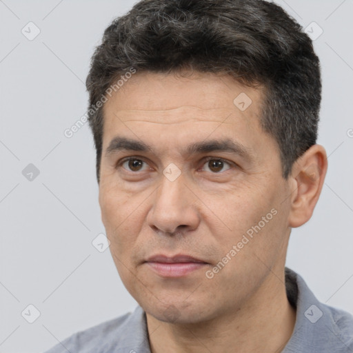 Joyful white adult male with short  black hair and brown eyes