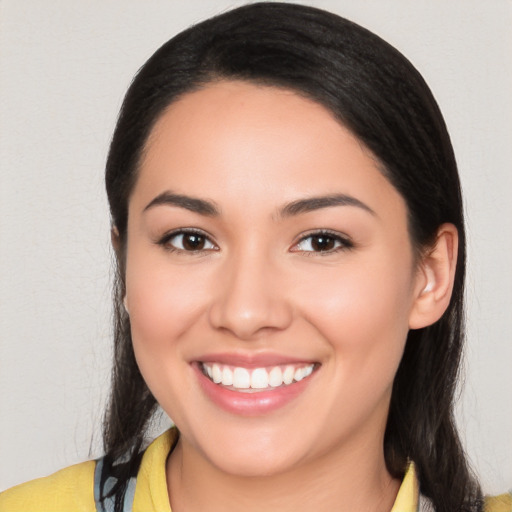 Joyful white young-adult female with long  black hair and brown eyes