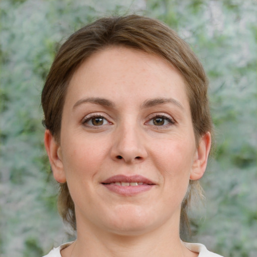 Joyful white young-adult female with medium  brown hair and grey eyes