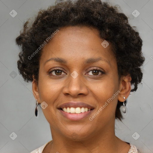 Joyful black young-adult female with short  brown hair and brown eyes