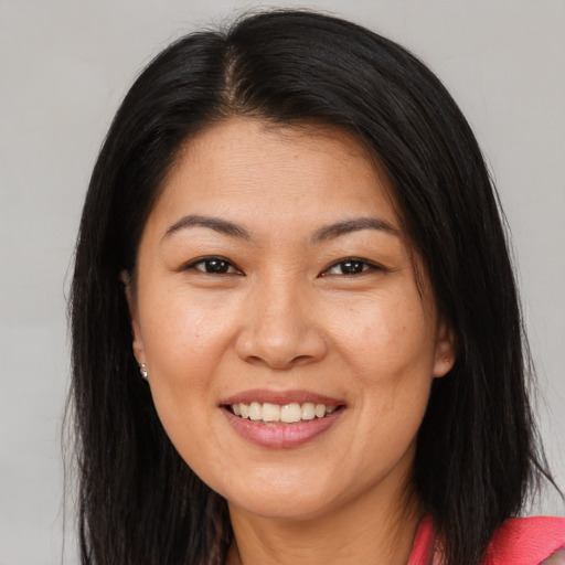 Joyful asian adult female with long  brown hair and brown eyes
