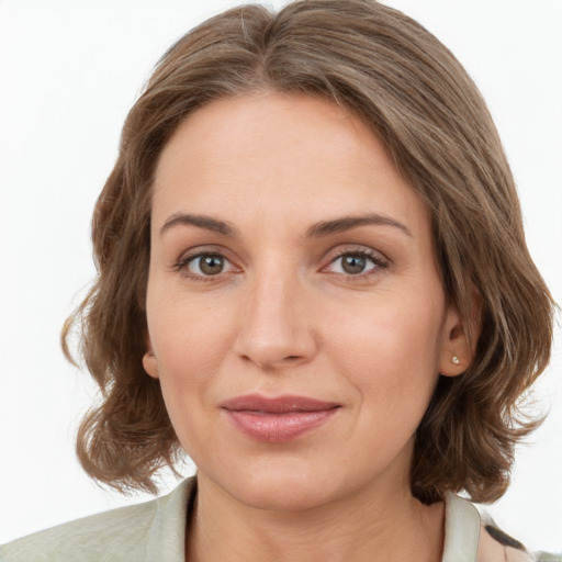 Joyful white young-adult female with medium  brown hair and green eyes