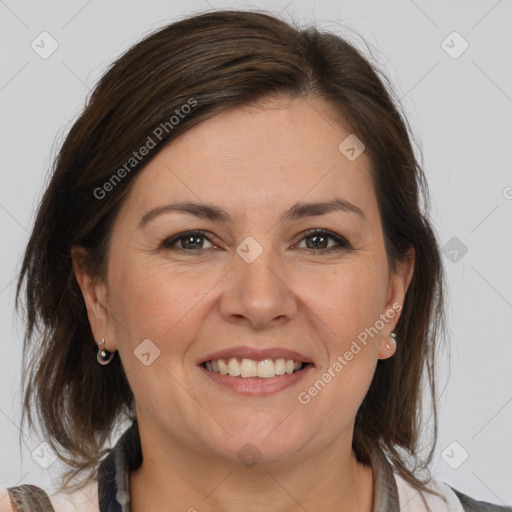 Joyful white adult female with medium  brown hair and brown eyes