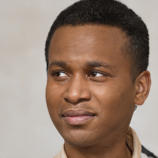 Joyful latino young-adult male with short  brown hair and brown eyes