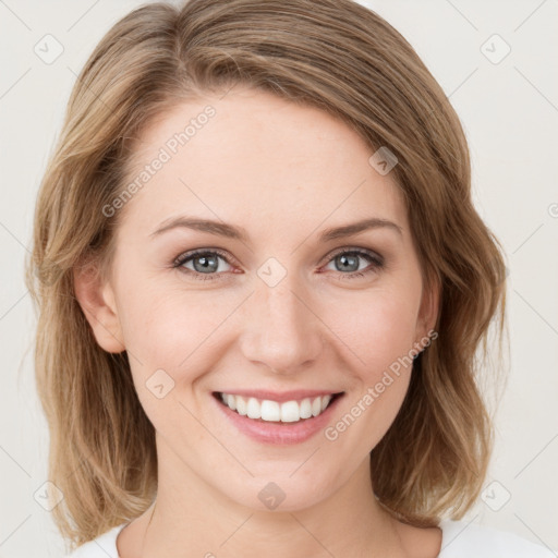 Joyful white young-adult female with medium  brown hair and green eyes