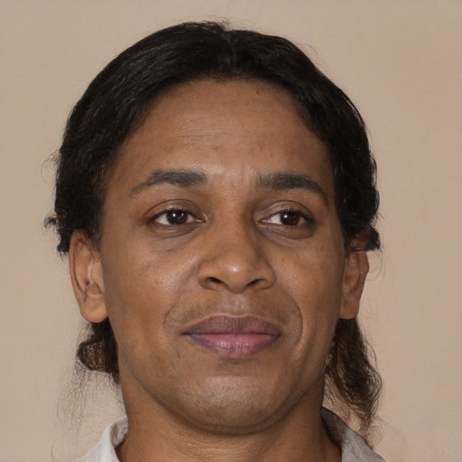 Joyful black adult male with medium  brown hair and brown eyes