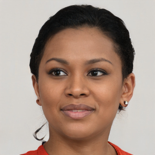 Joyful black young-adult female with short  black hair and brown eyes