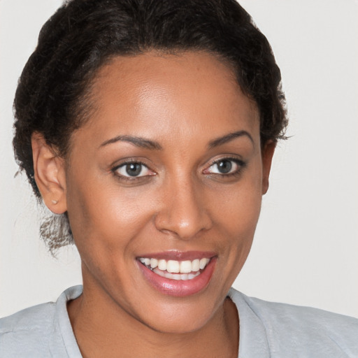 Joyful white young-adult female with short  brown hair and brown eyes