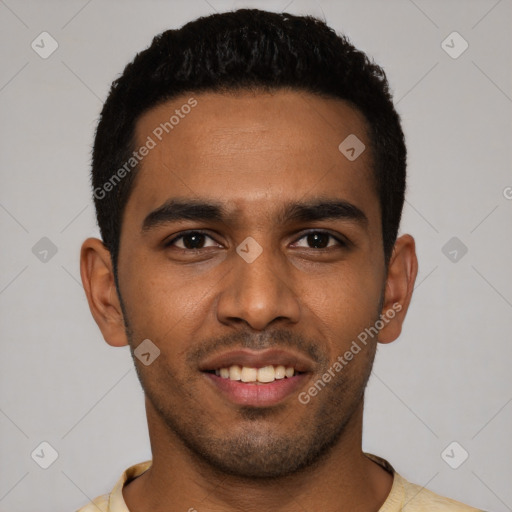 Joyful black young-adult male with short  black hair and brown eyes