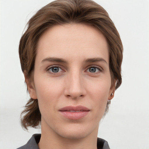 Joyful white young-adult female with medium  brown hair and grey eyes