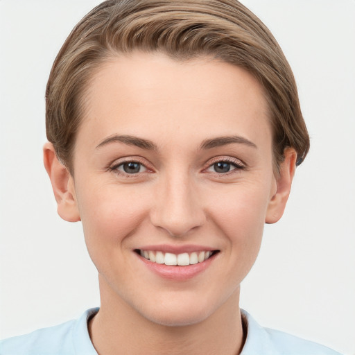 Joyful white young-adult female with short  brown hair and grey eyes