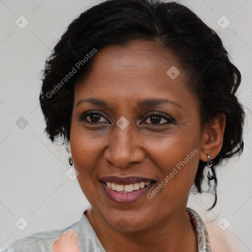 Joyful black adult female with medium  brown hair and brown eyes