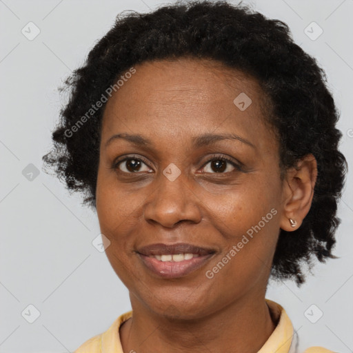 Joyful black adult female with short  brown hair and brown eyes