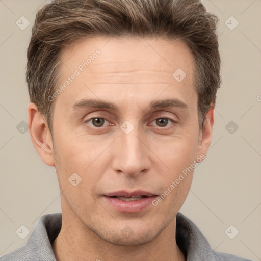 Joyful white adult male with short  brown hair and grey eyes