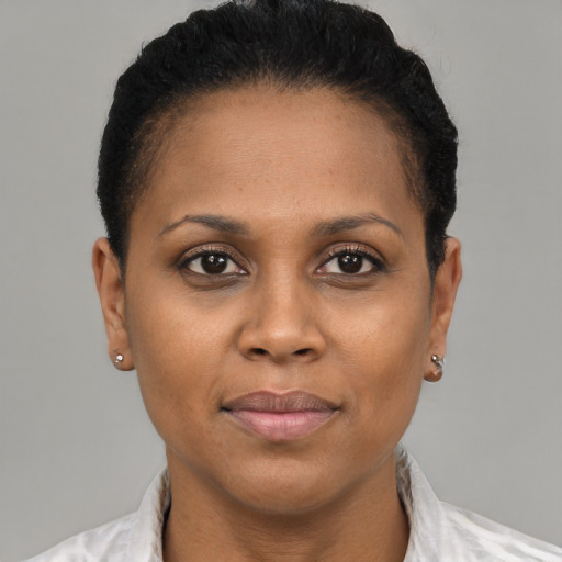 Joyful black adult female with short  brown hair and brown eyes