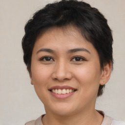 Joyful asian young-adult female with short  brown hair and brown eyes