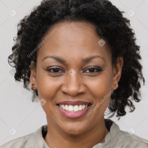 Joyful black adult female with short  brown hair and brown eyes