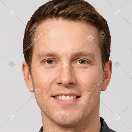 Joyful white young-adult male with short  brown hair and grey eyes