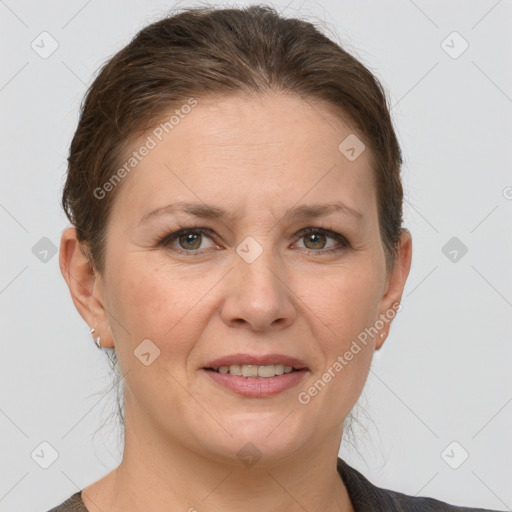 Joyful white adult female with short  brown hair and grey eyes