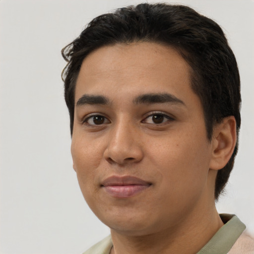 Joyful latino young-adult male with short  black hair and brown eyes
