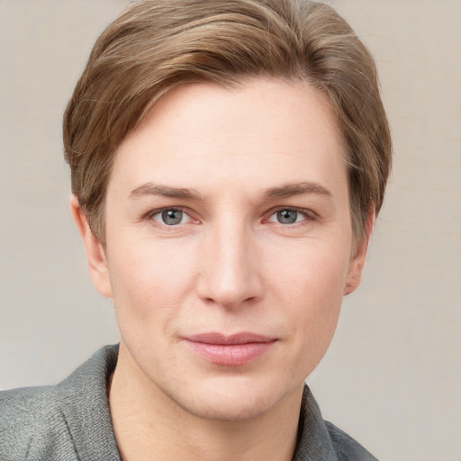 Joyful white young-adult female with short  brown hair and grey eyes