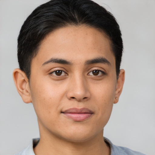 Joyful latino young-adult male with short  brown hair and brown eyes