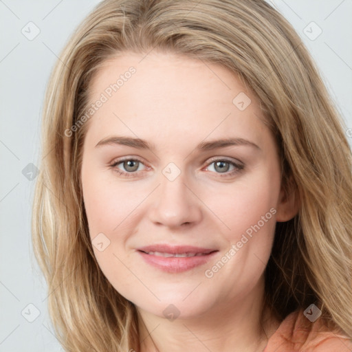 Joyful white young-adult female with long  brown hair and blue eyes