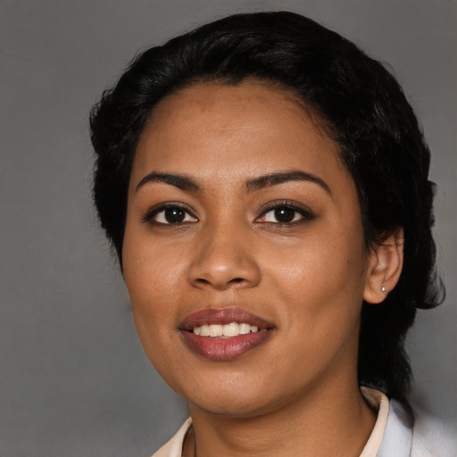 Joyful latino young-adult female with short  black hair and brown eyes