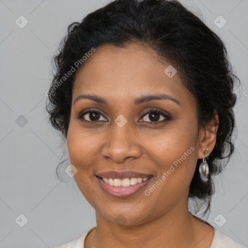 Joyful black young-adult female with medium  brown hair and brown eyes