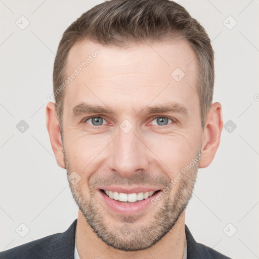 Joyful white young-adult male with short  brown hair and grey eyes