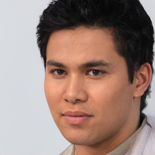 Joyful asian young-adult male with short  black hair and brown eyes