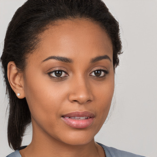 Joyful latino young-adult female with medium  brown hair and brown eyes