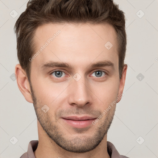 Joyful white young-adult male with short  brown hair and grey eyes