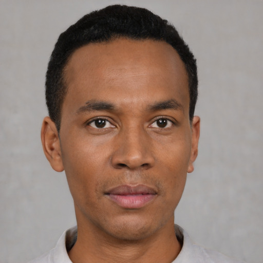Neutral latino young-adult male with short  black hair and brown eyes
