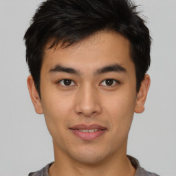 Joyful asian young-adult male with short  brown hair and brown eyes