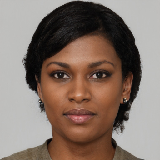 Joyful black young-adult female with medium  black hair and brown eyes