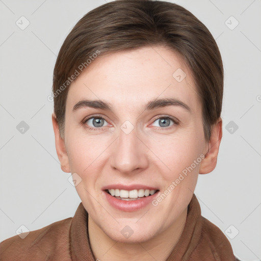 Joyful white young-adult female with short  brown hair and grey eyes