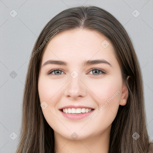 Joyful white young-adult female with long  brown hair and grey eyes