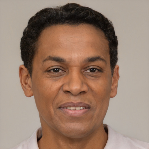 Joyful latino adult male with short  brown hair and brown eyes