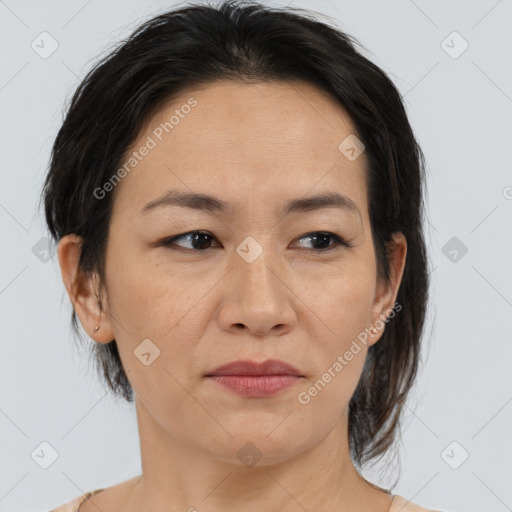 Joyful asian adult female with medium  brown hair and brown eyes