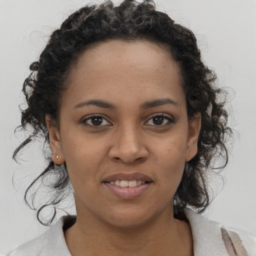 Joyful black young-adult female with medium  black hair and brown eyes