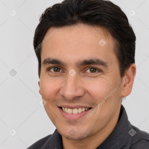 Joyful white adult male with short  brown hair and brown eyes